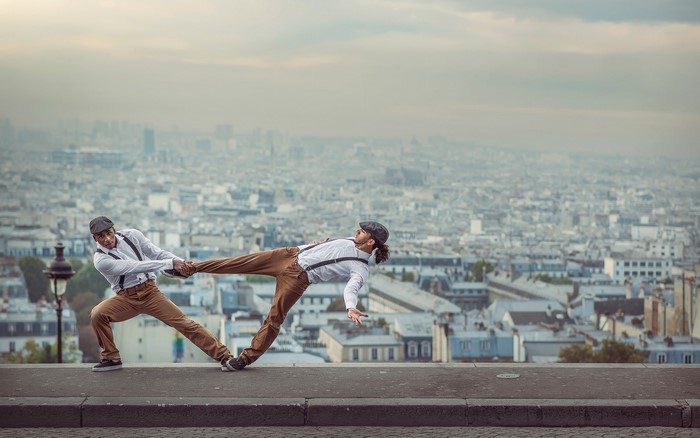 Two men dancing on a ledge in Paris