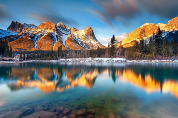 Mountaintops reflected in a lake in Canmore, Alberta, Canada