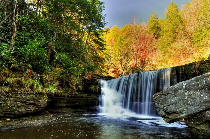 Waterfall in Autumn Forest with Rocks