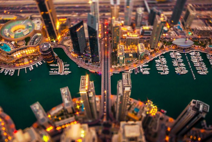 Dubai Marina at night with boats and bridges