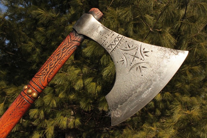 Close-up of a Viking battle axe with carved handle