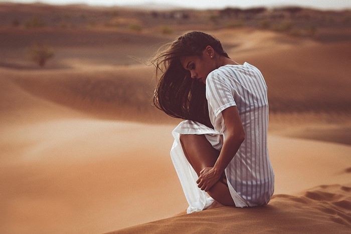 Woman sitting in a desert