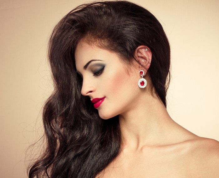 Brunette girl with makeup and earrings
