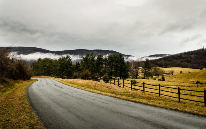 Winding Road Through Rural Landscape with Mountains
