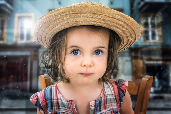 Young girl in straw hat and plaid shirt