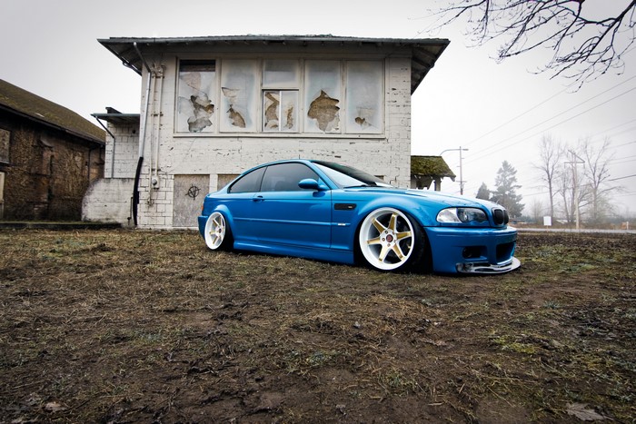 Blue BMW E46 M3 parked near abandoned building