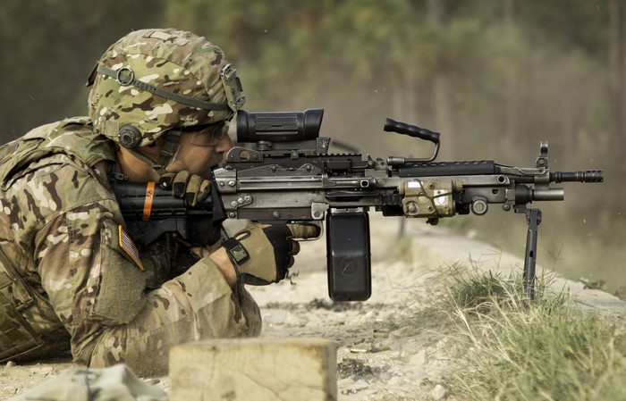 Soldier firing a machine gun