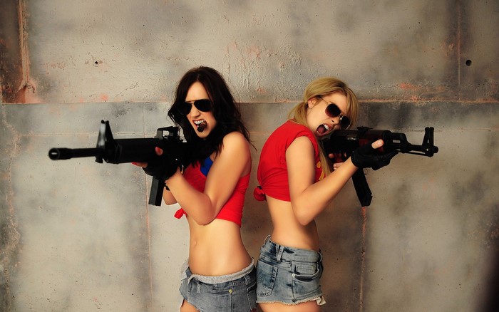 Two women with assault rifles
