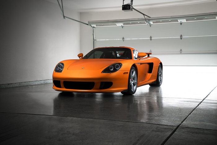 Orange Porsche Carrera GT in a Garage
