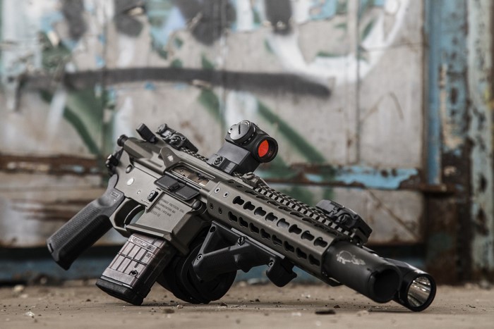 AR-15 pistol with drum magazine and red dot sight