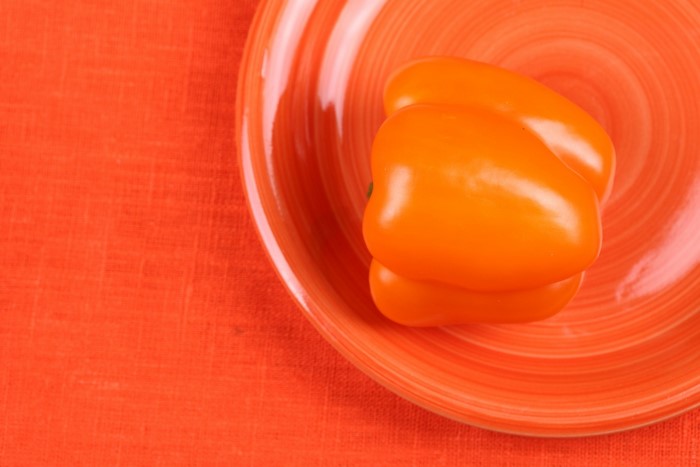 Two orange bell peppers on a plate