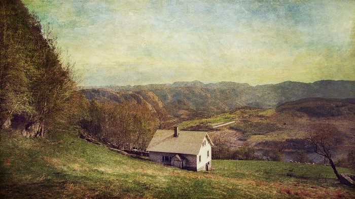A house in a mountainous landscape with a textured effect