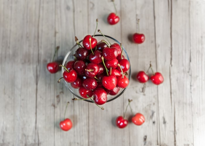 Cherries in a bowl on a wooden table