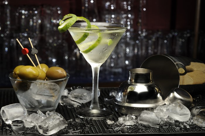 Cocktail with lime and olives on ice