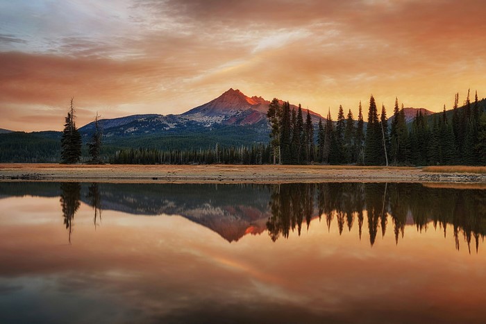 Mountain reflected in lake at sunset