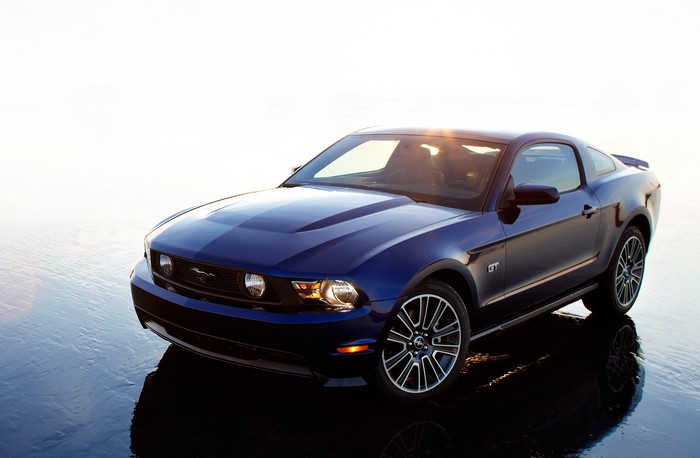 Blue 2010 Ford Mustang GT on wet surface