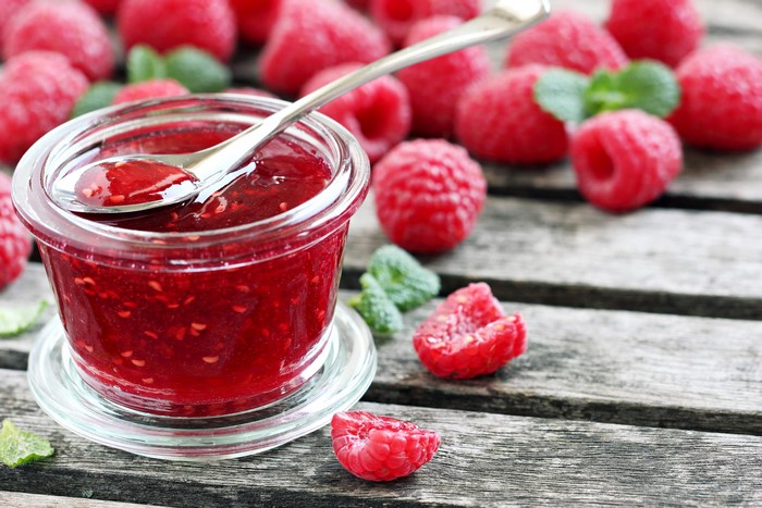 Raspberry Jam in a Jar with Spoon and Raspberries