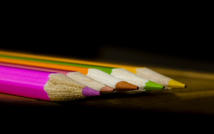 Close-up of colorful pencils on a wooden surface