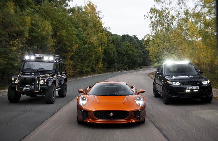 Jaguar C-X75 and two Land Rovers on a road