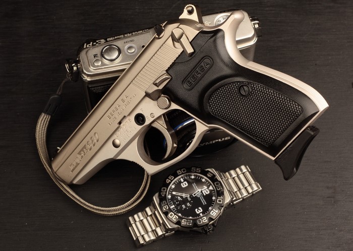 Bersa Thunder 380 pistol with Olympus camera and watch