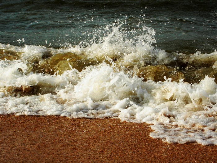 Ocean waves crashing on a sandy beach