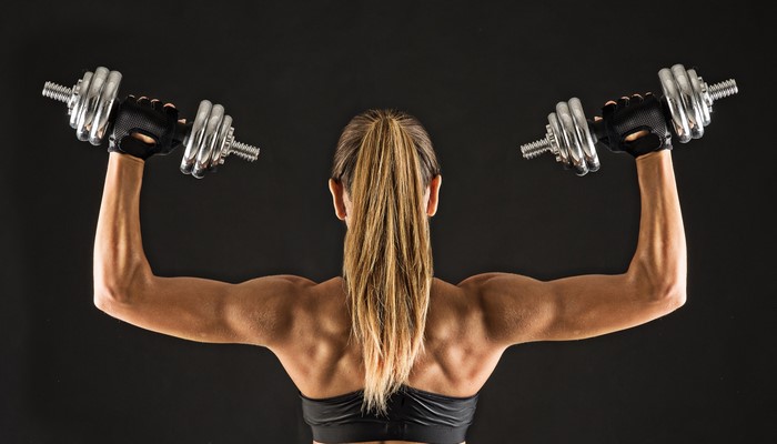 Muscular Woman Lifting Dumbbells with 4K Clarity
