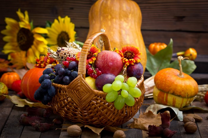 Autumn harvest with fruits, pumpkins, and sunflowers