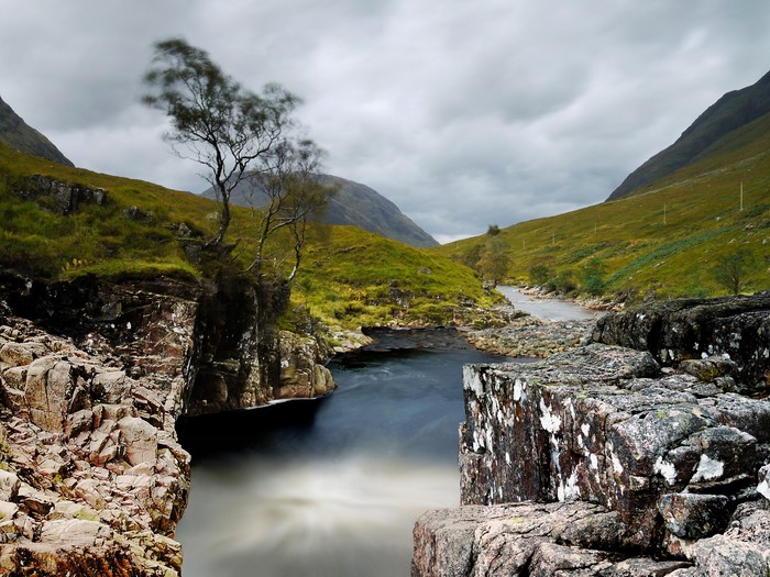 River flowing through a valley with mountains and rocks