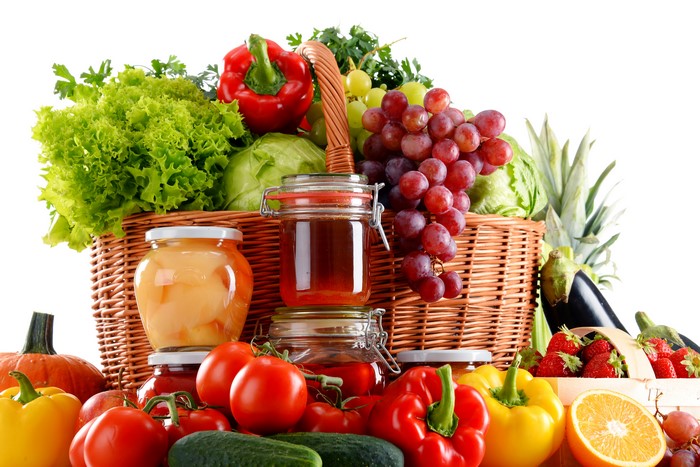 Fruit and Vegetables in a Wicker Basket with Jars