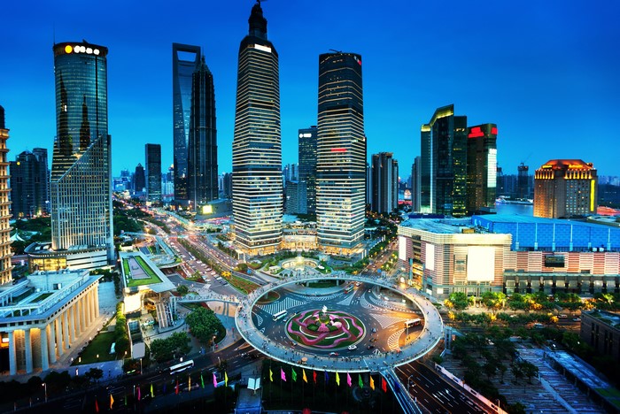 Shanghai city skyline with skyscrapers and busy roads at night