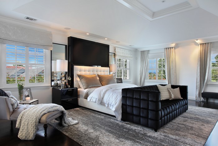 Luxury Bedroom with Large Bed and Black Sofa