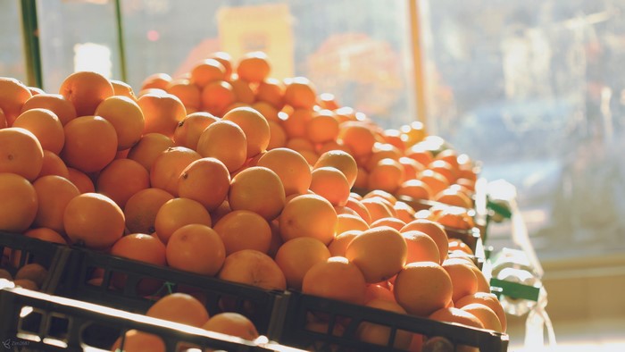 Pile of oranges in black crates