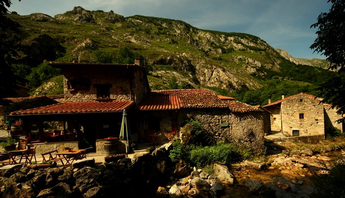 Stone houses in Bulnes, Spain, with mountains