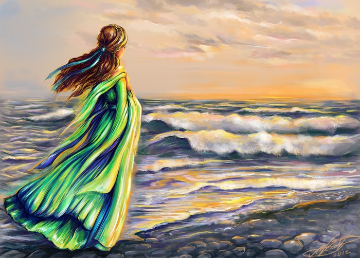 Woman in green dress by the sea at sunset