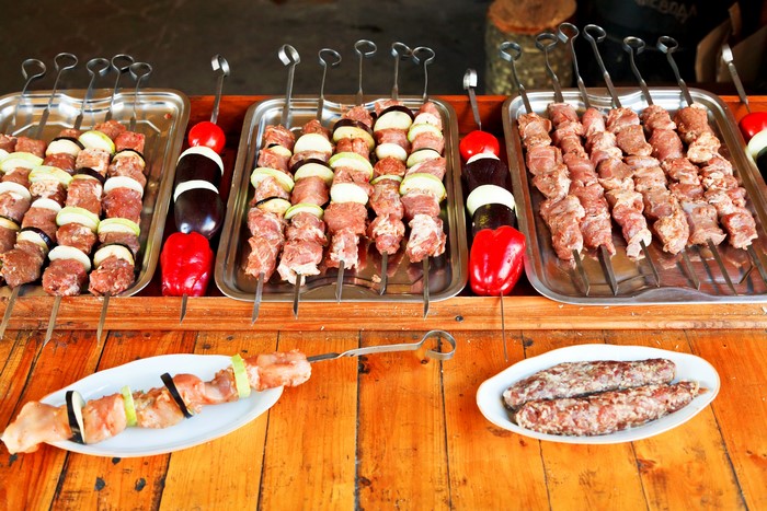 Raw meat and vegetable skewers on trays