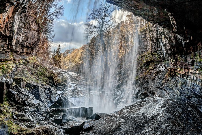 Waterfall cascading over rocks in a cave