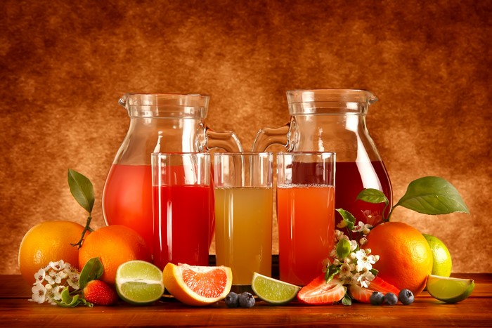 Juice in pitchers and glasses with fruits