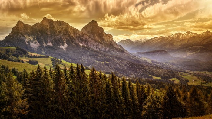 Mountains and forests with golden clouds