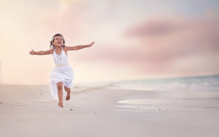 Little girl running on a beach