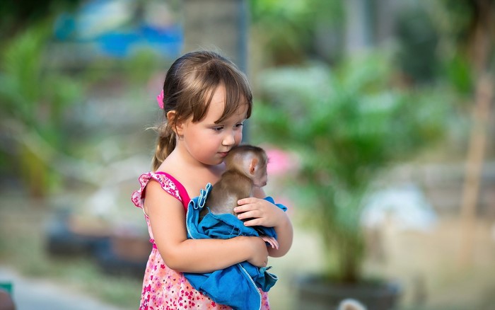 Girl holding a monkey