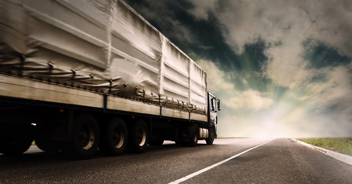 Truck on a Road Under a Dramatic Sky