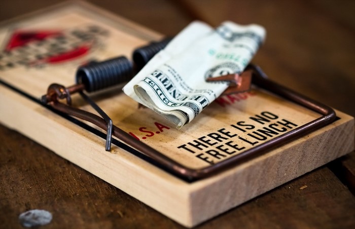 Money on a mouse trap with text