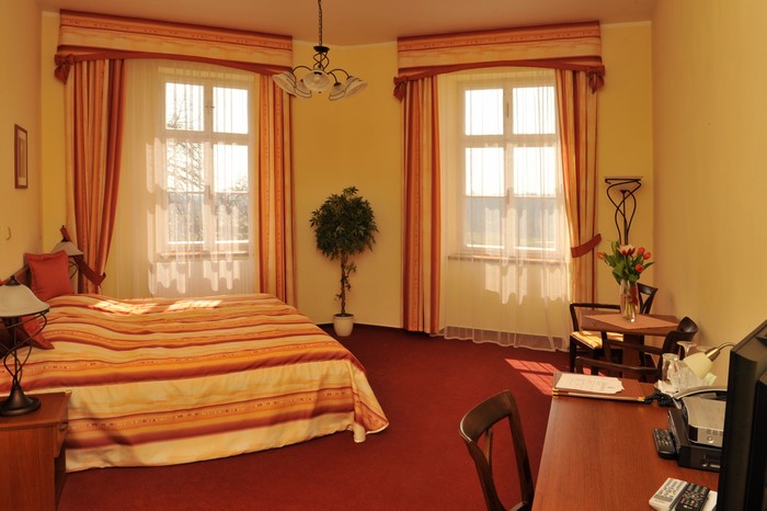 Bedroom with two windows and a bed