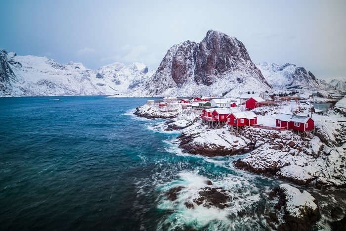 Red houses on snowy coast of Lofoten, Norway