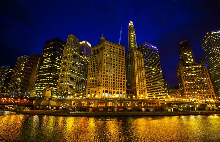 Chicago city skyline at night over the river