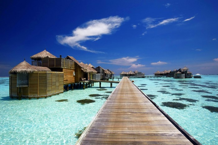 Overwater bungalows and wooden pier in the Maldives