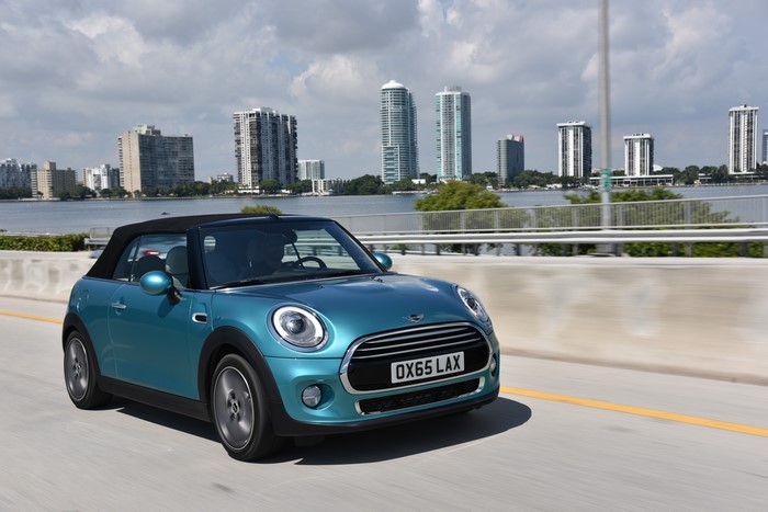 Metallic Teal Mini Cooper Convertible on Highway