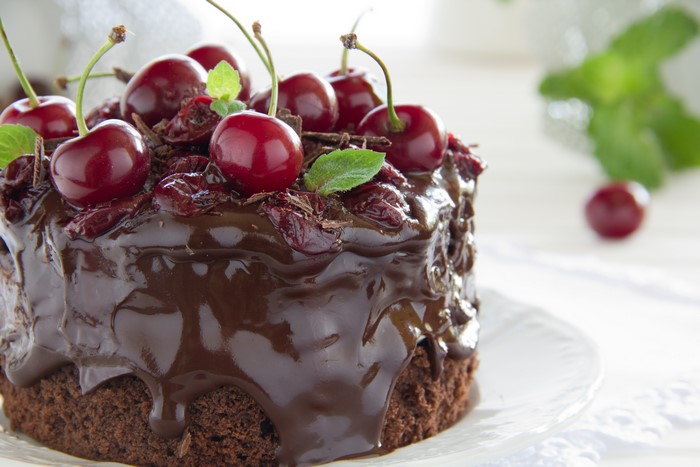 Chocolate cake with cherries and chocolate shavings