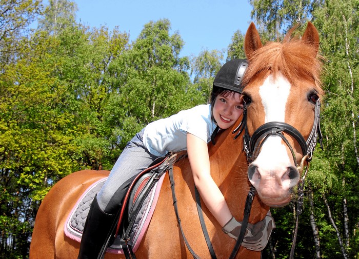 Girl hugging a horse