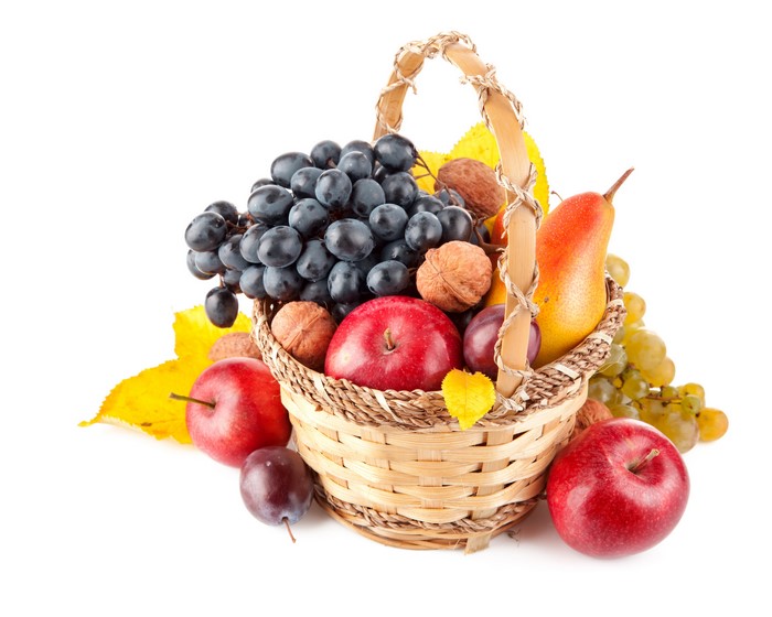Fruit in a wicker basket with autumn leaves